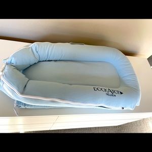 The DockATot Deluxe+ is multifunctional docking station for babies. Light blue.